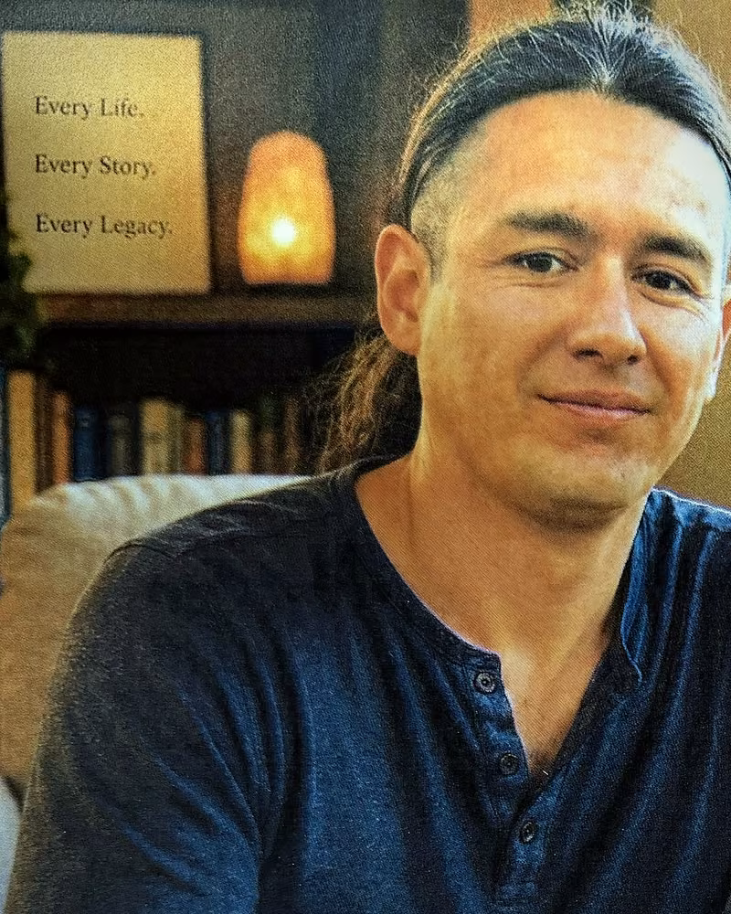 Ivan Martinez seated in a warm, book-lined room.